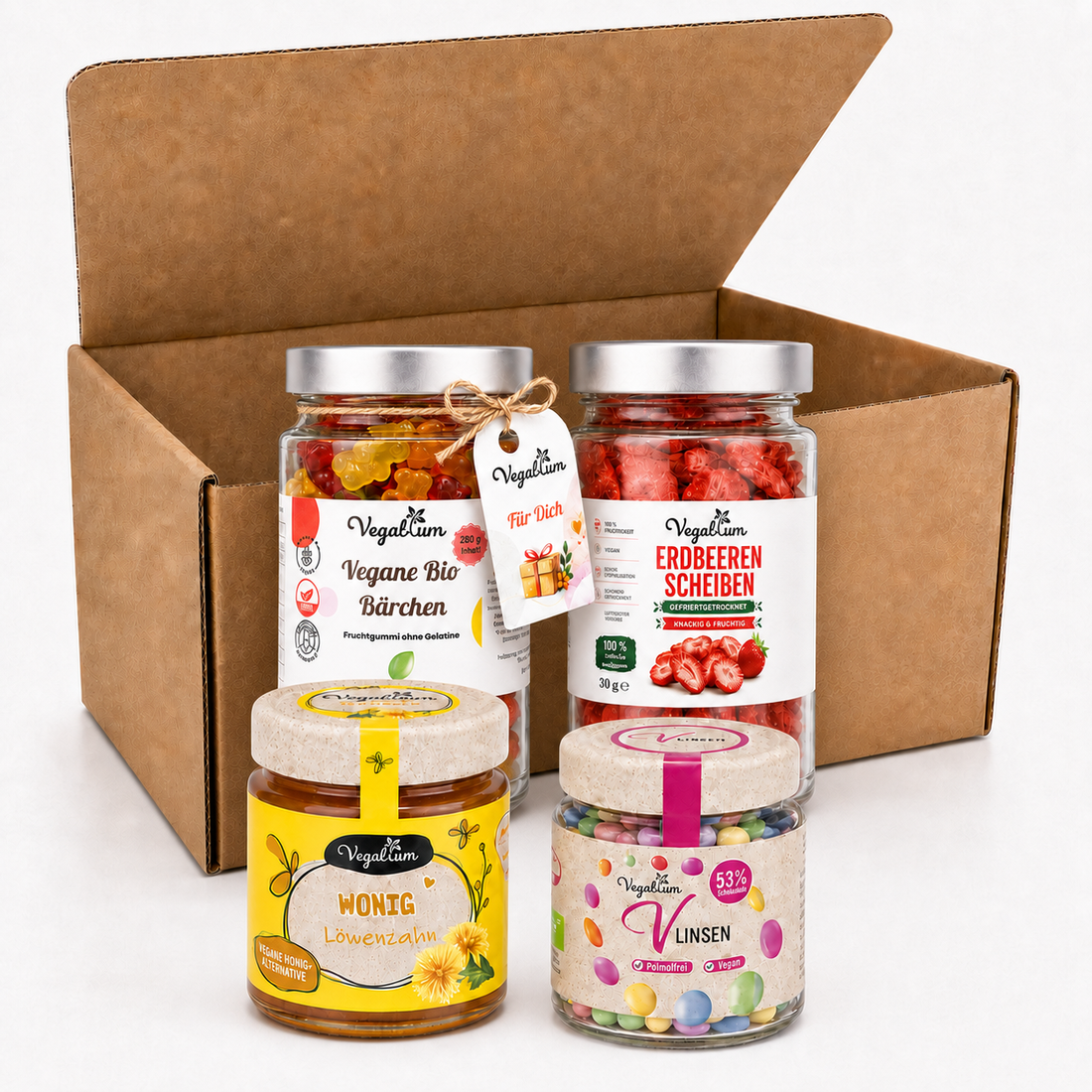 Veganes Geschenkset von Vegablum mit gleich großen Gläsern Bio Bärchen und Erdbeerscheiben sowie Wonig Löwenzahn und Vlinsen